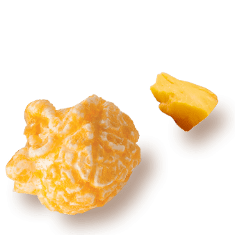 A picture of a kernel flavored Cheddar Cheese next a chuck of cheese.