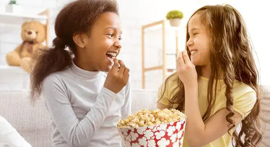 kids snacking on Popcornopolis® gourmet popcorn together